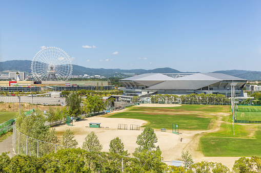 Osaka, Japan - August 31 2016: Suita City Football Stadium, sports ground, and Redhorse Osaka Wheel in Expocity