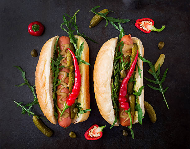istock Hot dog with pickles, capers and arugula 599977244
