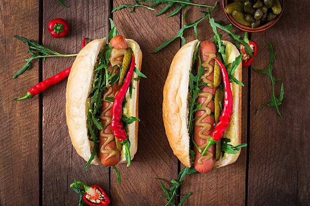 istock Hot dog with pickles, capers and arugula 599977474