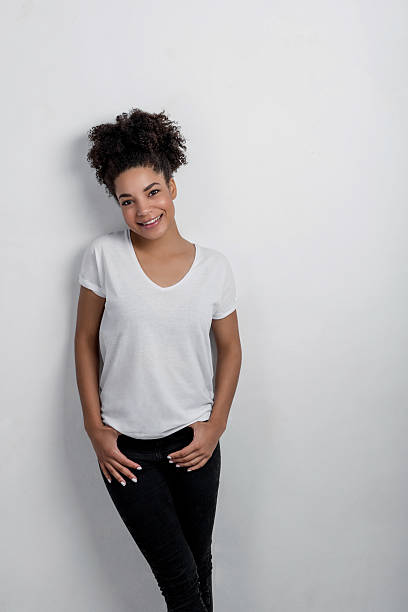istock Smiling young African woman posing against a white background 599978008