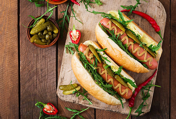 istock Hot dog with pickles, capers and arugula 599978168