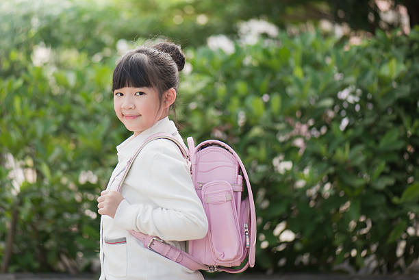 istock Asian school girl with pink backpack 599978990