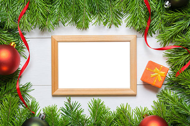 istock Christmas fir tree with blank frame on a wooden table 599980610