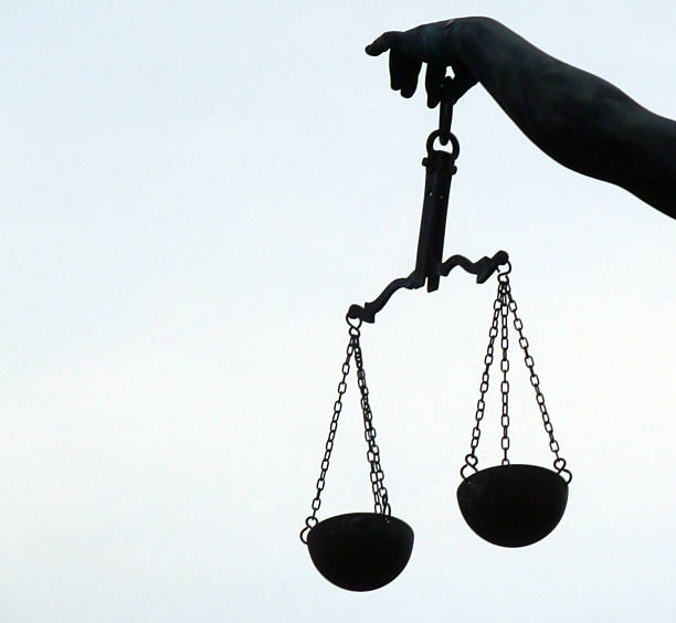 istock Large Hand Holding Justice Weight Scale Against Sky In Frankfurt 599981850