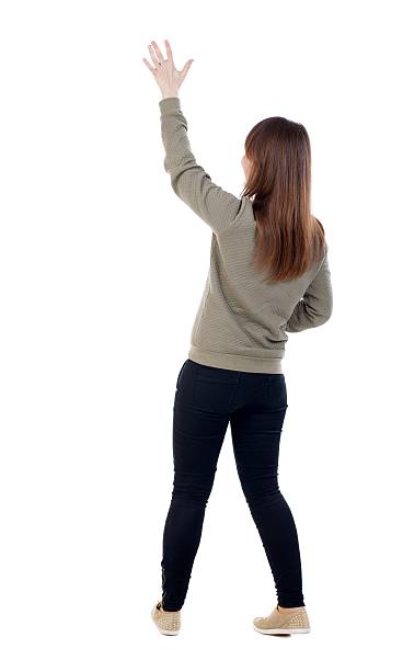istock Back view of beautiful woman welcomes. 599982530