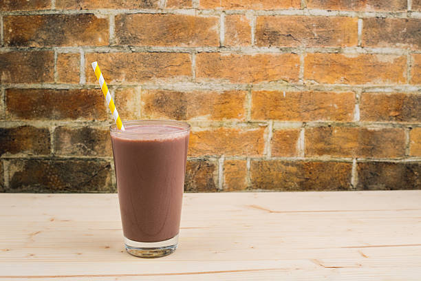 A healthy peanut butter and strawberry jam smoothie, topped with Greek yogurt and strawberries.