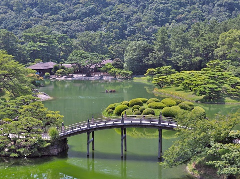 Kagawa, Japan - July 22, 2016: A view from a hill in Ritsurin Garden in Takamatsu city, Kagawa Prefecture, Japan. Ritsurin Garden is one of the most famous historical gardens in Japan.