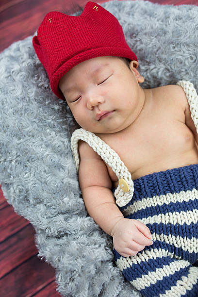istock Cute baby boy sleeping in a basket 599985504