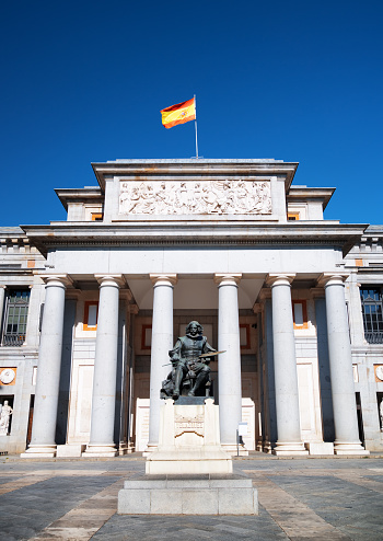 Madrid, Spain - August 20, 2014: Bronze statue of Diego Velazquez is beside the Museo del Prado in Madrid, Spain. Madrid is a popular tourist destination of Europe.