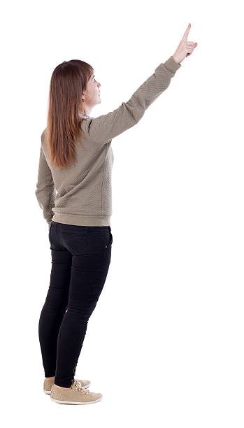 istock Back view of  pointing woman. 599986666