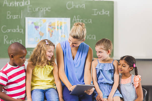 istock Teacher teaching kids on digital tablet 599987490