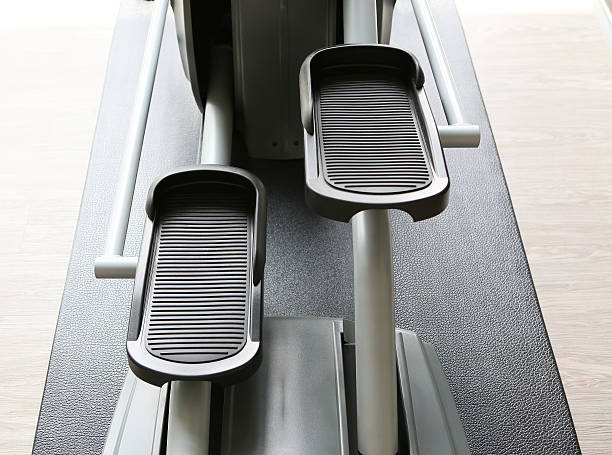 istock Elliptical cross trainer machine in exercise room for sport 599989256