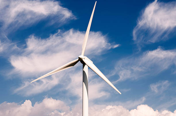 istock wind turbine against partly cloudy blue sky 599989350