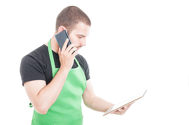 istock Young employee holding tablet and speaking at phone 599993386