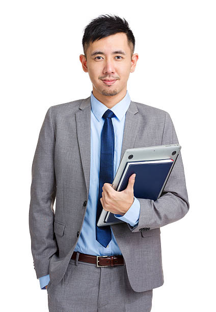 istock Chinese businessman holding laptop and notebook 599994186