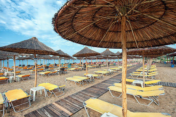 Umbrellas and chairs on the beach, in Flogita, Halkidiki Greece stock photo