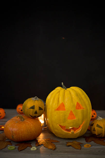 istock Halloween pumpkin head jack lantern on wooden background 599995554