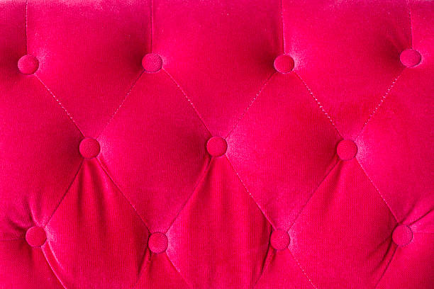 istock Red velvet couch background texture with sunken buttons 599995686