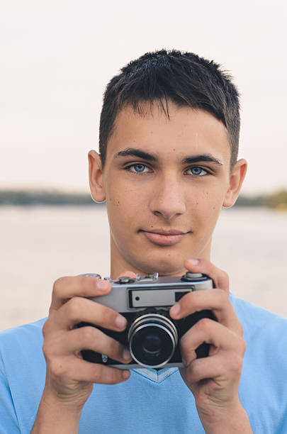 cute boy teenager with vintage rangefinder camera. - photographer enjoyment elegance old fashioned imagens e fotografias de stock