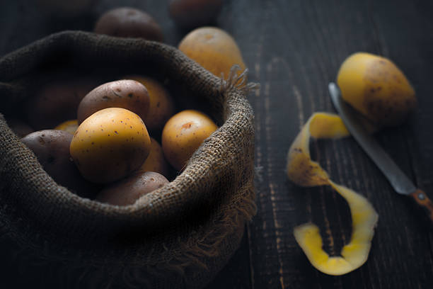 istock Potatoes in the canvas bag  on the wooden table 599998732