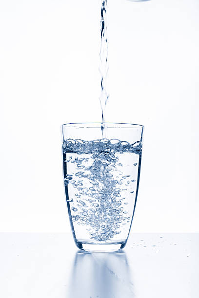 istock water splashing from glass isolated on white background 599998990