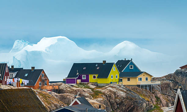 Iulissat, stranded icebergs, Greenland The city of Iulissat with stranded icebergs in the background, Greenland ilulissat icefjord stock pictures, royalty-free photos & images