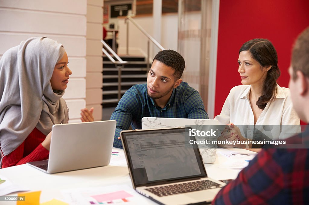 Group Of Students Meeting For Tutorial With Teacher Teacher Stock Photo