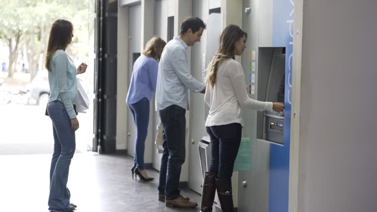 People in line waiting to withdraw money from ATM