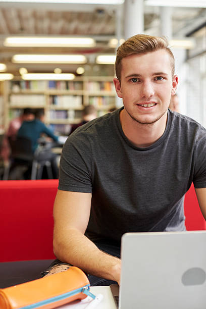 istock Portrait Of Male University Student Working In Library 600055098