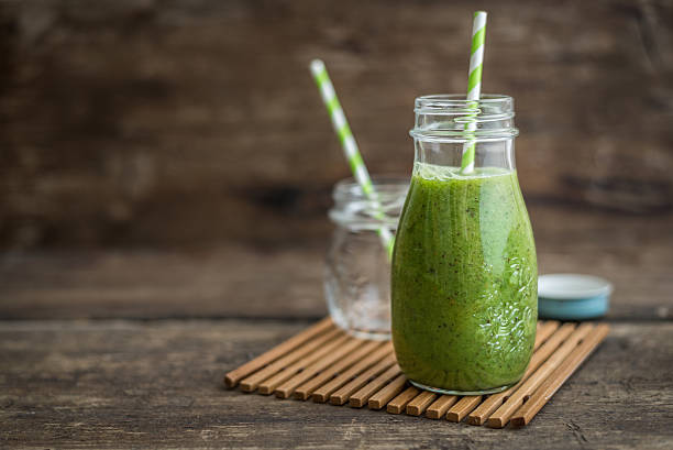 Green Smoothie Fresh Green Smoothie on Rustic Wood smoothie stock pictures, royalty-free photos & images