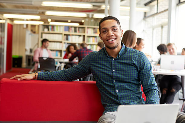 istock Portrait Of Male University Student Working In Library 600055138