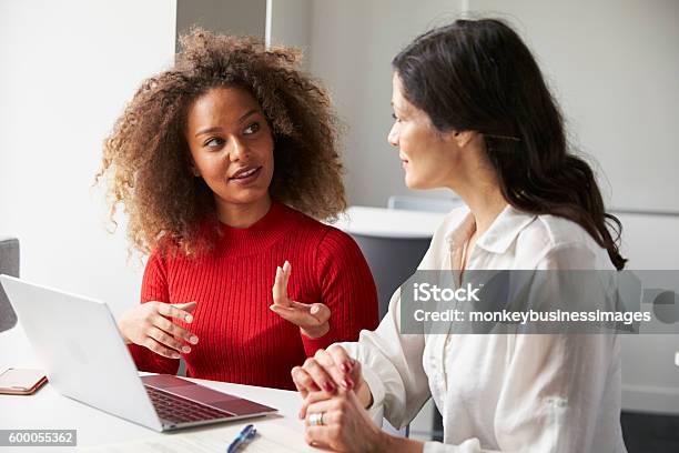 Female University Student Working One To One With Tutor Stock Photo - Download Image Now
