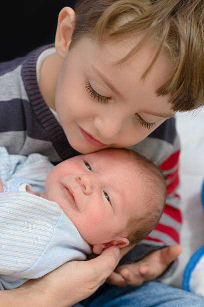 istock Curious Boy holding his little brother 600055906