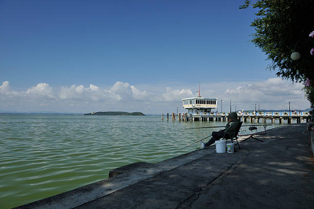 Photo of Balaton Lake in Siofok, Hungary. Dramatic Cloudy sky and blue, tourquise water.