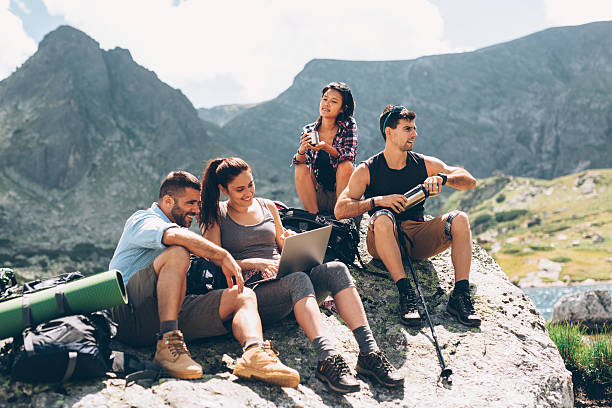 istock Friends browsing the net in the mountain 600056612