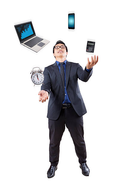 istock Businessman juggling with business items 600057614