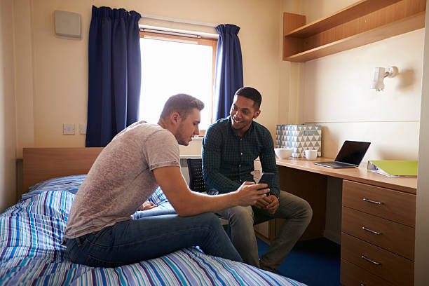 istock Male Students Working In Bedroom Of Campus Accommodation 600057810
