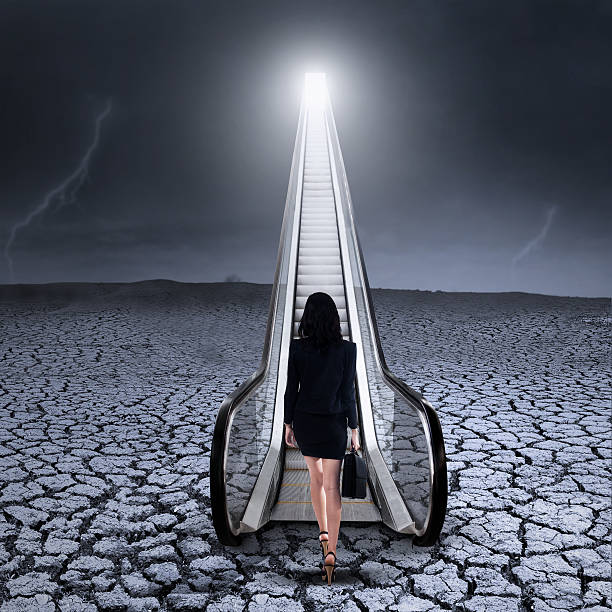 istock Businesswoman stepping up an escalator 600058052