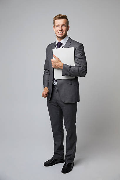 istock Studio Portrait Of Businessman Holding Clipboard 600058074