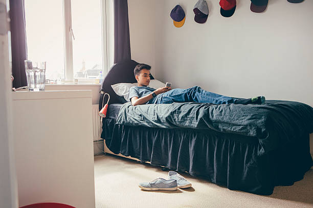 istock Teenager using Smartphone at Home 600058132