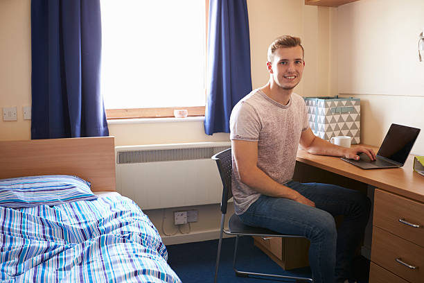 istock Male Student Working In Bedroom Of Campus Accommodation 600058218