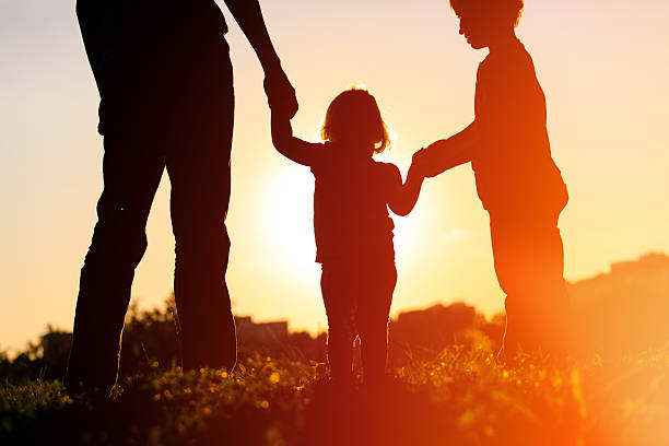 istock father with son and daughter walk at sunset 600060488