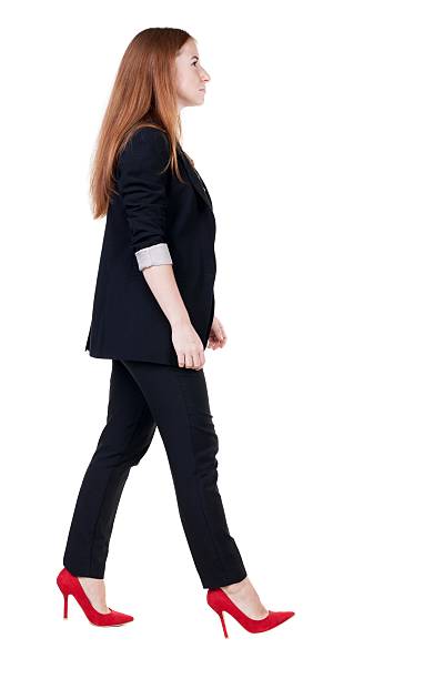 istock walking red head business woman. 600060766