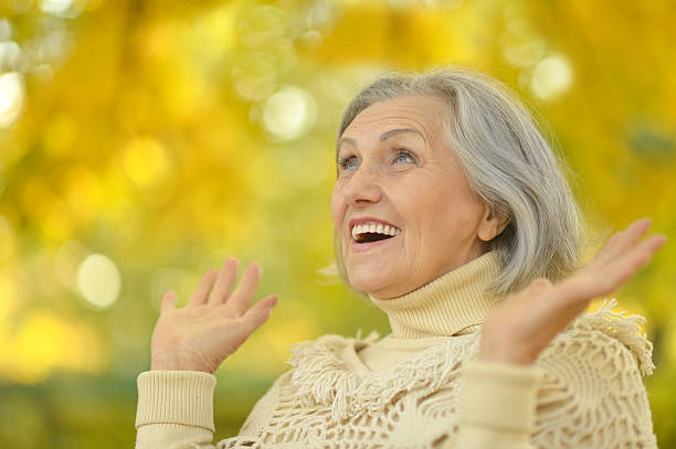 istock senior woman in  autumn park 600060884
