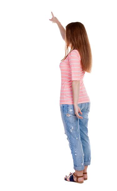 istock Back view of  pointing woman. 600060978