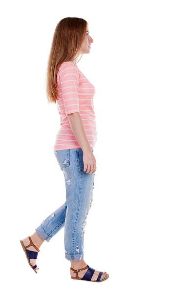 istock back view of walking  woman . 600061776