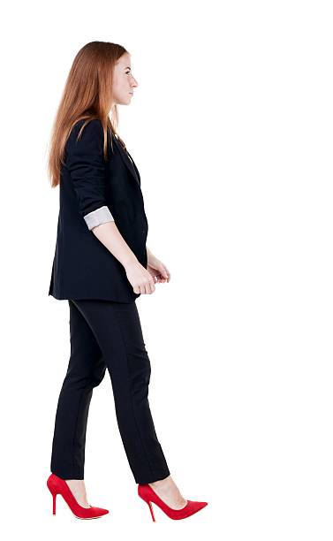 istock walking red head business woman. 600061808