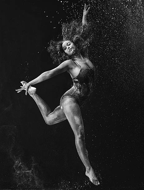 Dancing is a form of visual art Black and white shot of a young dancer against a grey background attraction studio photography stock pictures, royalty-free photos & images