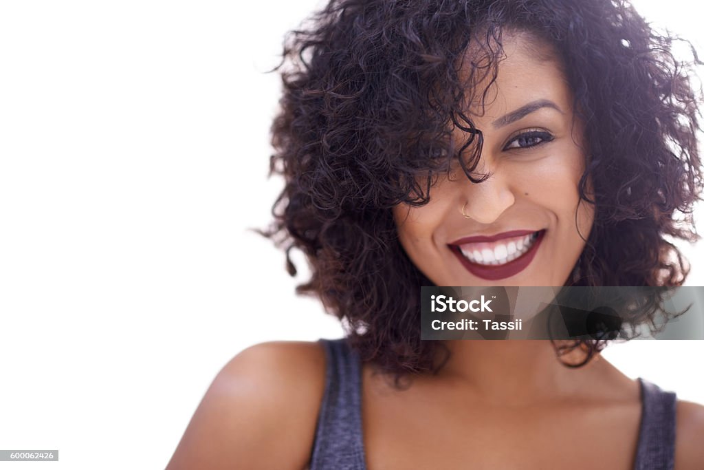 Yep, curly hair girls have it all Cropped shot of a beautiful woman with curly hair posing against a white background Women Stock Photo