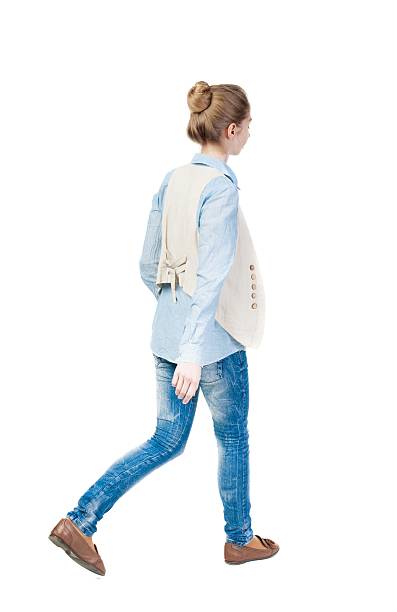 istock back view of walking  woman. 600062764